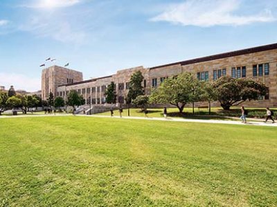 UQ's Forgan Smith building with green lawn in the foreground.